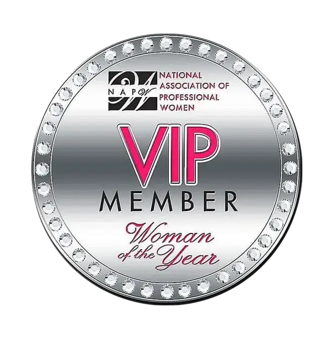 A silver circular badge with the text VIP Member in pink and Woman of the Year below. It features a border of diamonds and the logo of the National Association of Professional Women at the top.