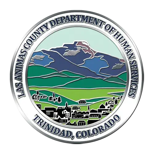 Seal of Las Animas County Department of Human Services, Trinidad, Colorado. Features an illustration of mountains, fields, and a town with various buildings.