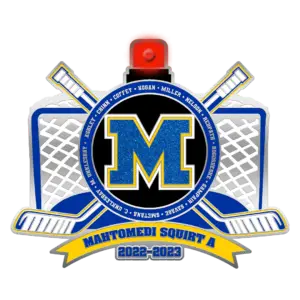 A hockey-themed badge with a large blue M in the center. Surrounding the M are crossed hockey sticks and nets. Below is a yellow banner reading MAHTOMEDI SQUIRT A 2022-2023. Names encircle the central emblem.