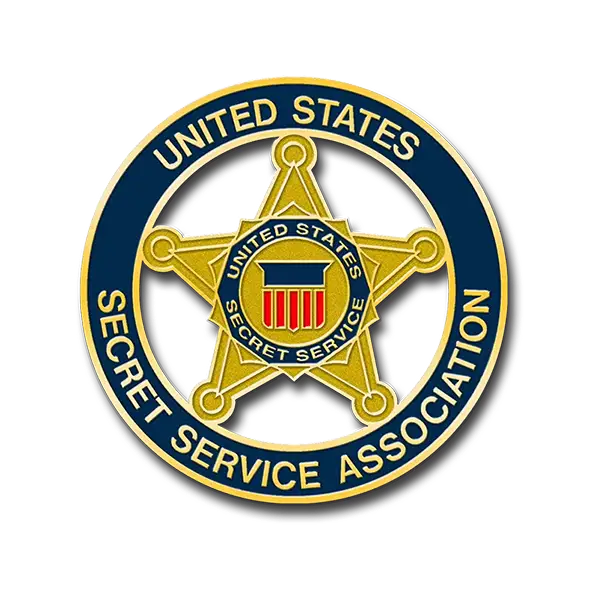 Seal of the United States Secret Service Association, featuring a gold star with a red, white, and blue shield at the center. Encircled by a blue ring with gold text reading United States Secret Service Association. A collectors gem akin to exclusive Cooperstown trading pins.